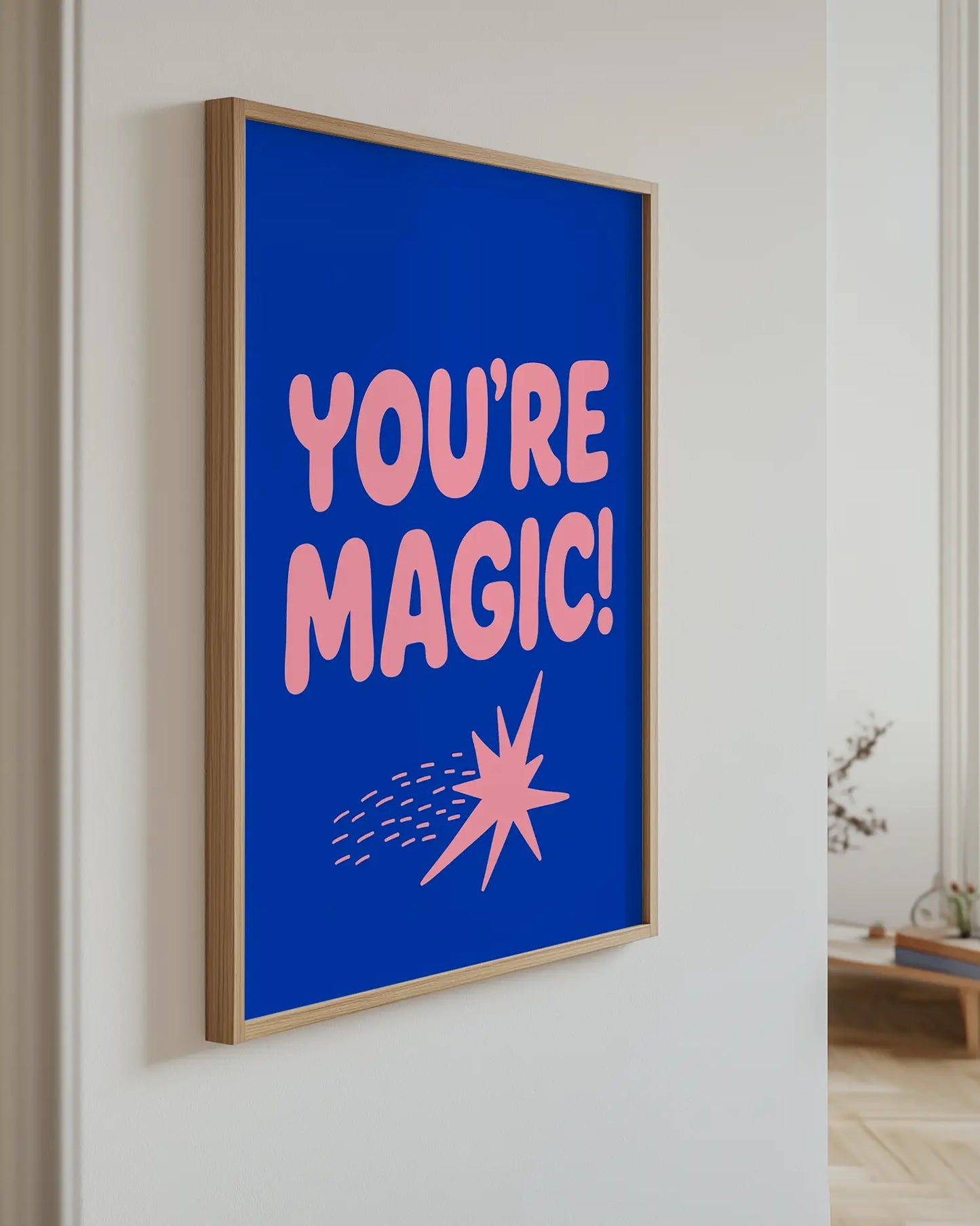 Barnrumstavla med texten "YOU’RE MAGIC!" i rosa typografi upphängd på vägg i ekram. En modern och inspirerande detalj som passar i lekfulla miljöer.
