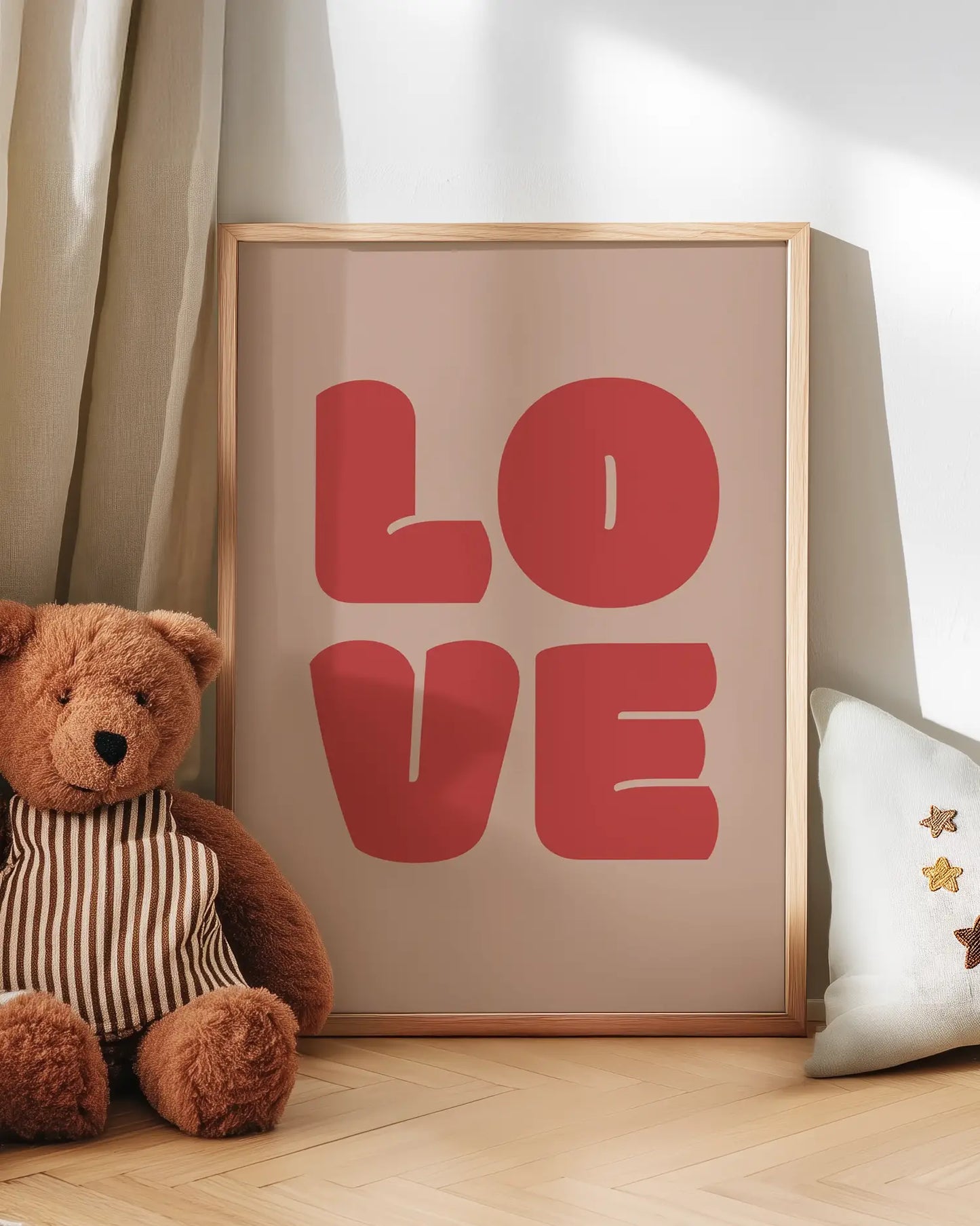 Barntavla med ordet "LOVE" i stora röda bokstäver, lutad mot vägg bredvid en nalle. En gullig och trygg väggdetalj för barnrummet.