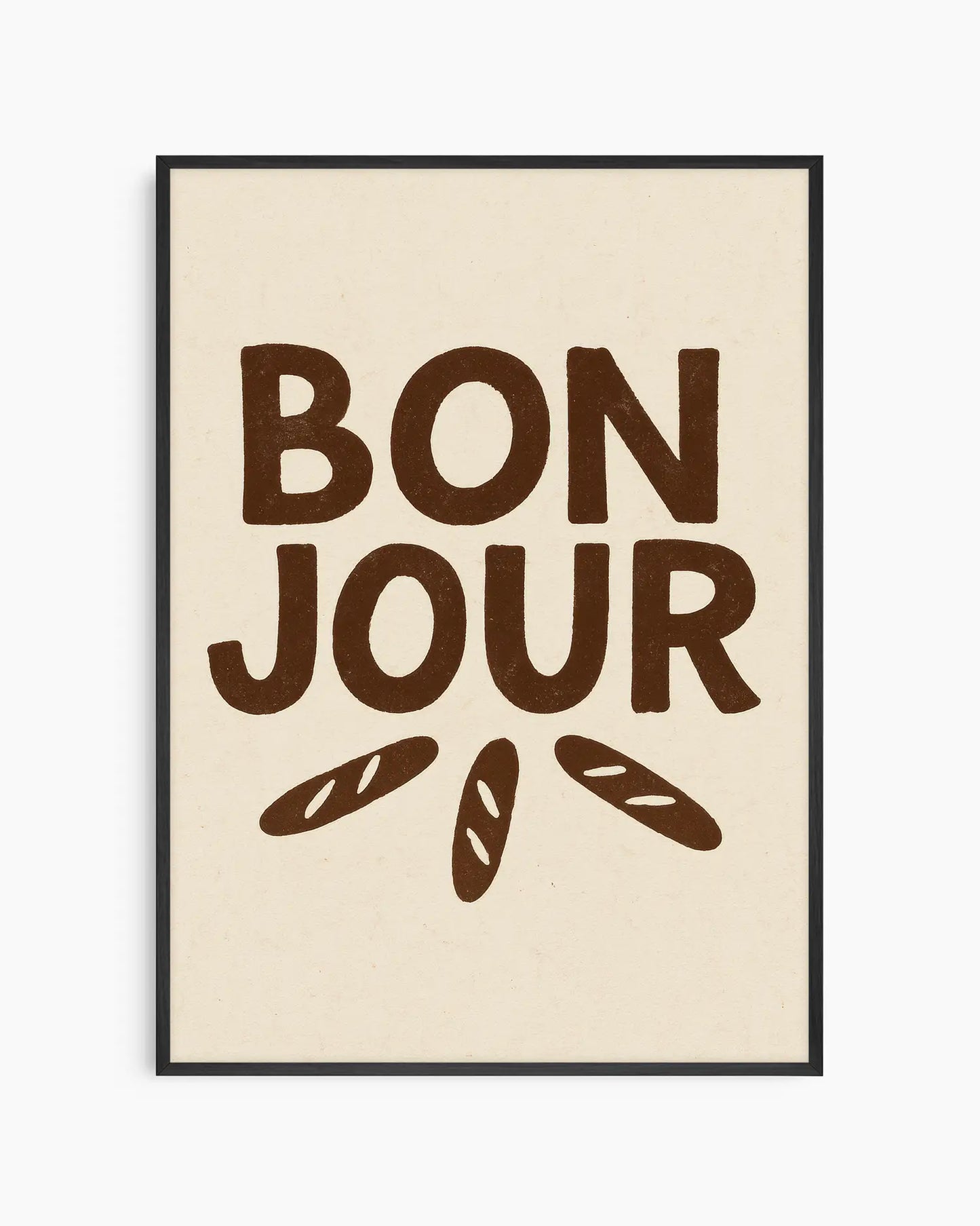 Barntavla med texten "BON JOUR" i mörkbruna, handritade versaler och tre små baguettebröd under, på ljus beige bakgrund, inramad i svart träram. En lekfull väggdekoration med fransk känsla.