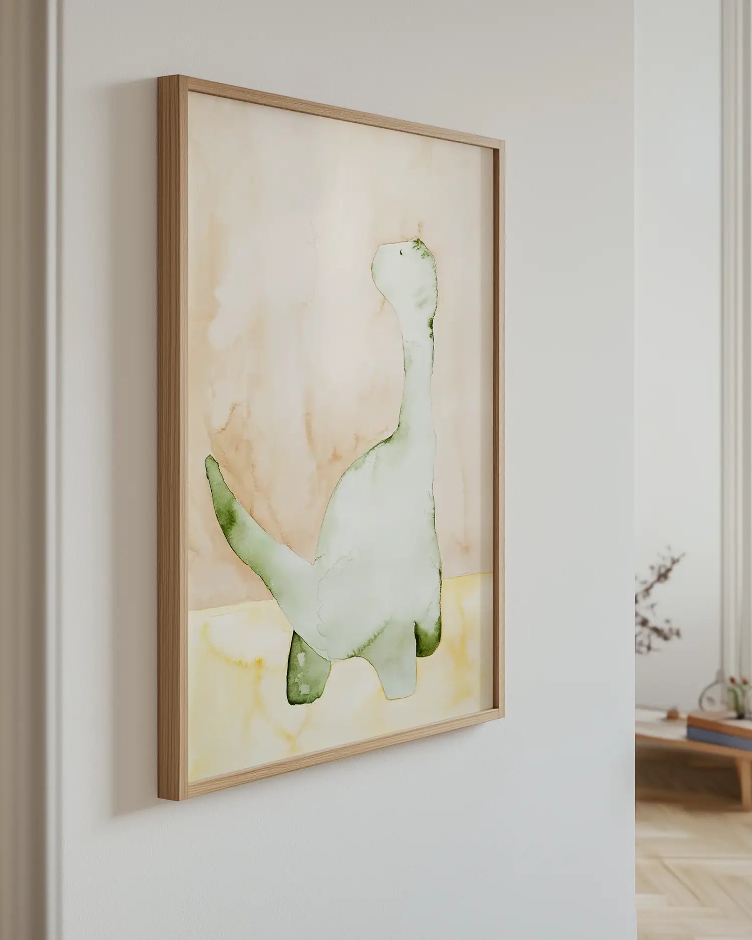 Barnrumstavla med akvarellmålad grön dinosaurie upphängd på vägg i ekram. En dekorativ och lugn detalj som passar i barnrummet.