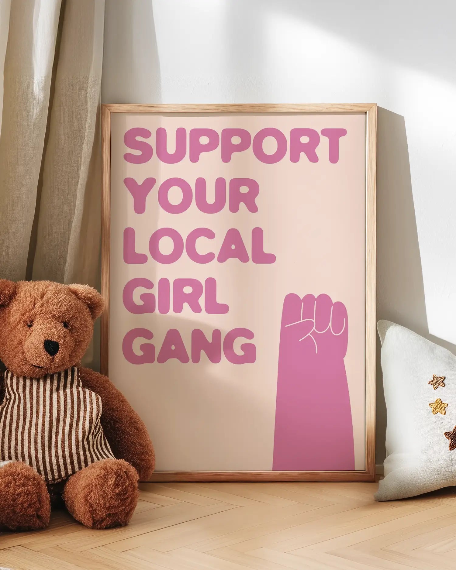 Barntavla med rosa text “Support your local girl gang” lutad mot vägg bredvid nalle. En söt och uppmuntrande väggdekoration för barnrummet.