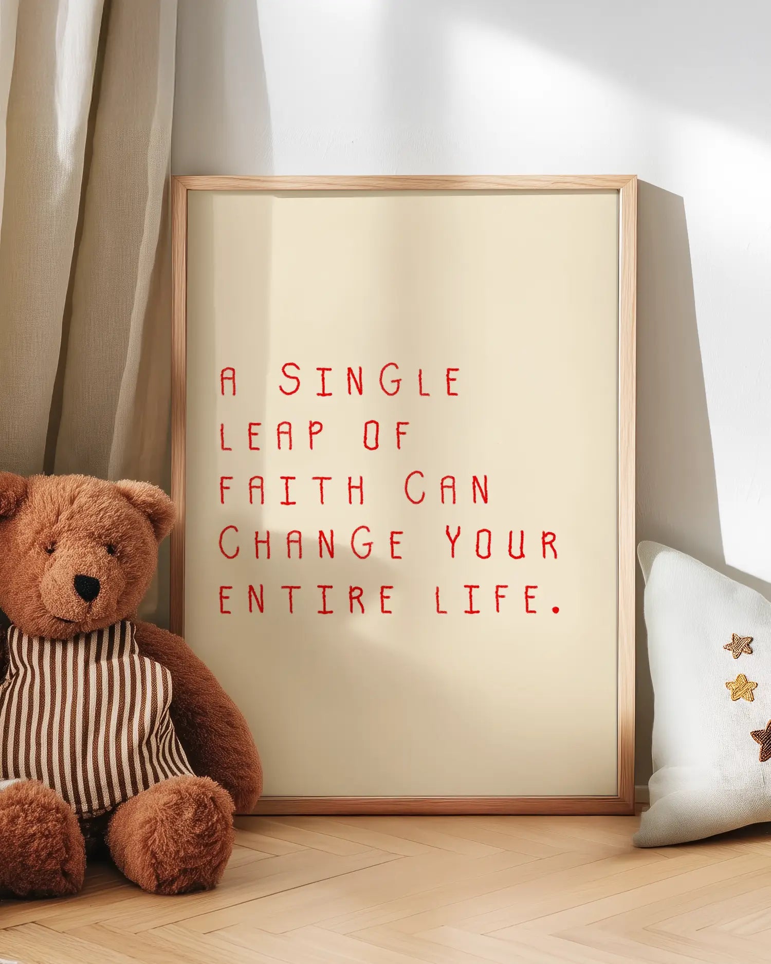 Barntavla med röd text “A single leap of faith can change your entire life.” lutad mot vägg bredvid nalle. En charmig och hoppfull scen med mjukt uttryck.