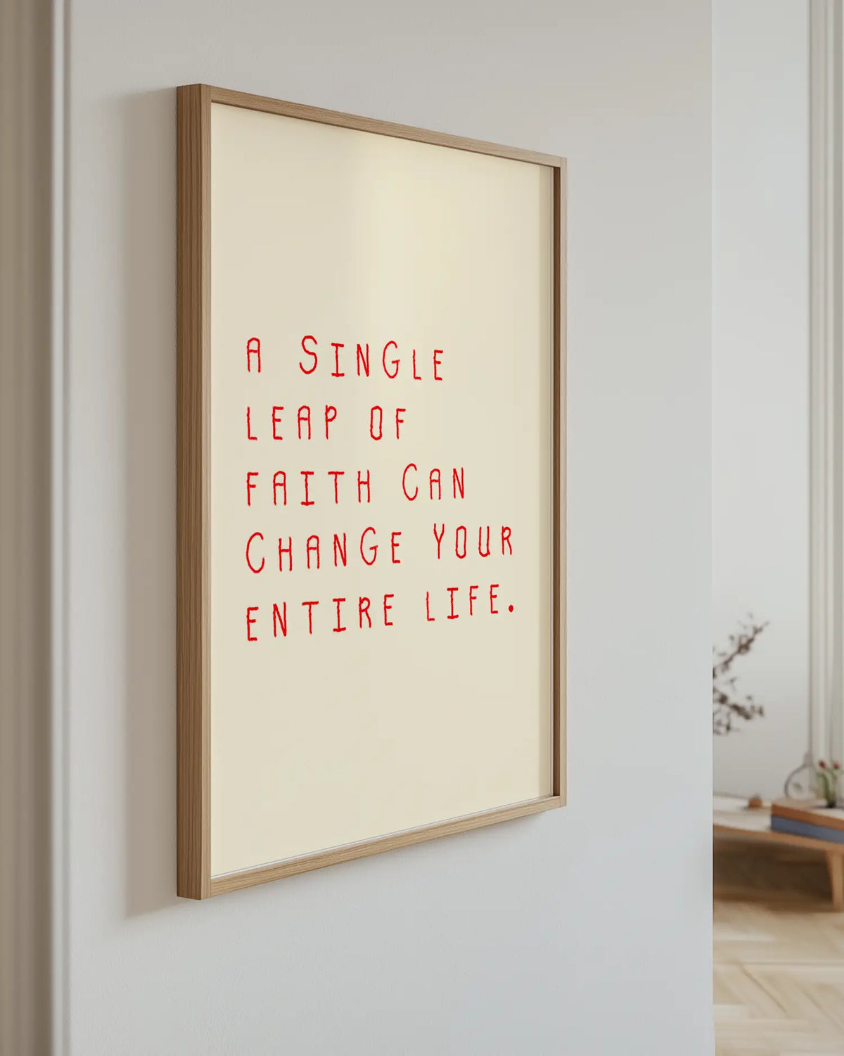 Barntavla med röd text “A single leap of faith can change your entire life.” upphängd på vägg med ekram. En vacker och inspirerande dekoration som sprider positiv energi.
