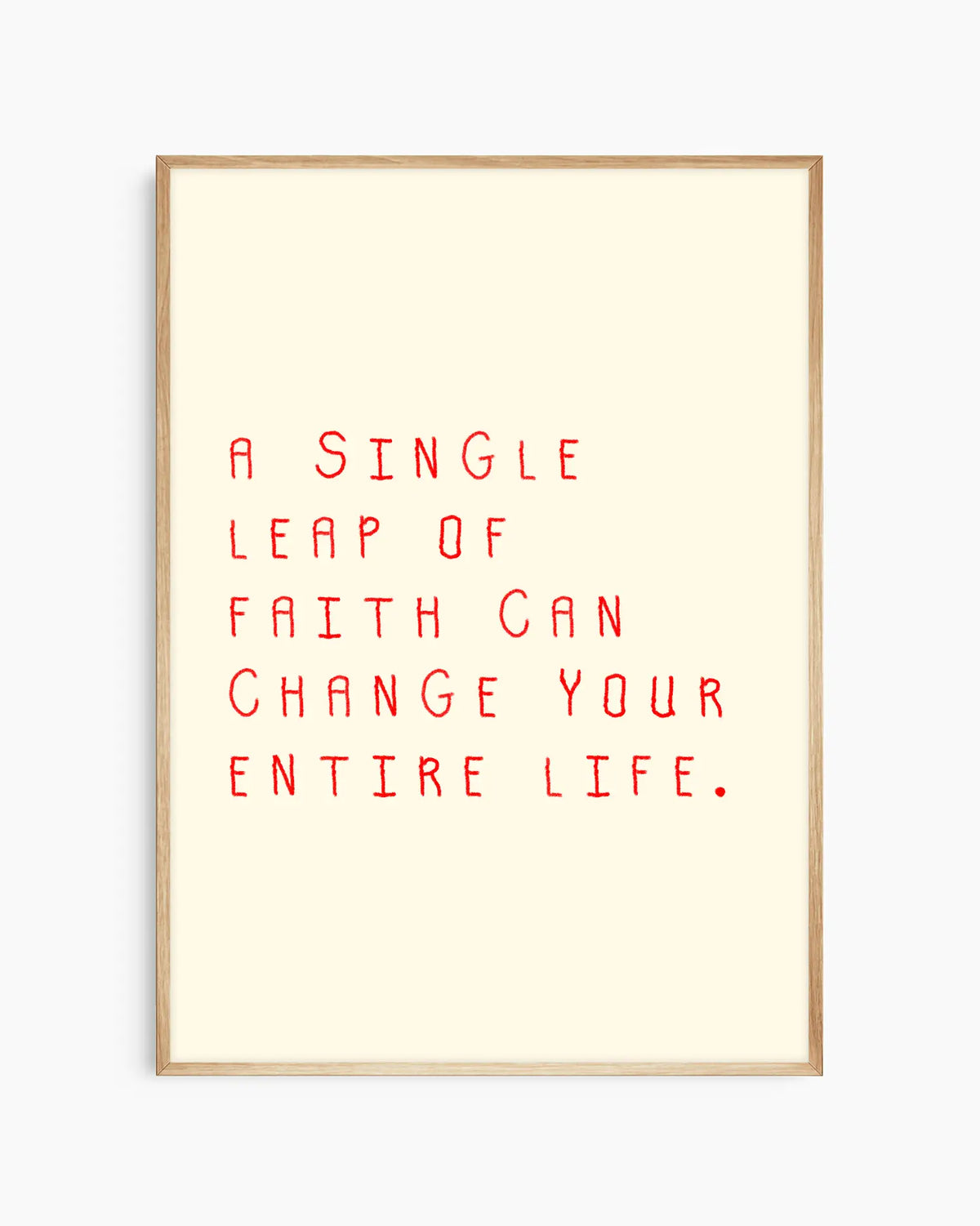 Barntavla med röd text “A single leap of faith can change your entire life.” på beige bakgrund, inramad i ekram. En naturlig och harmonisk väggdekoration som inspirerar till mod.