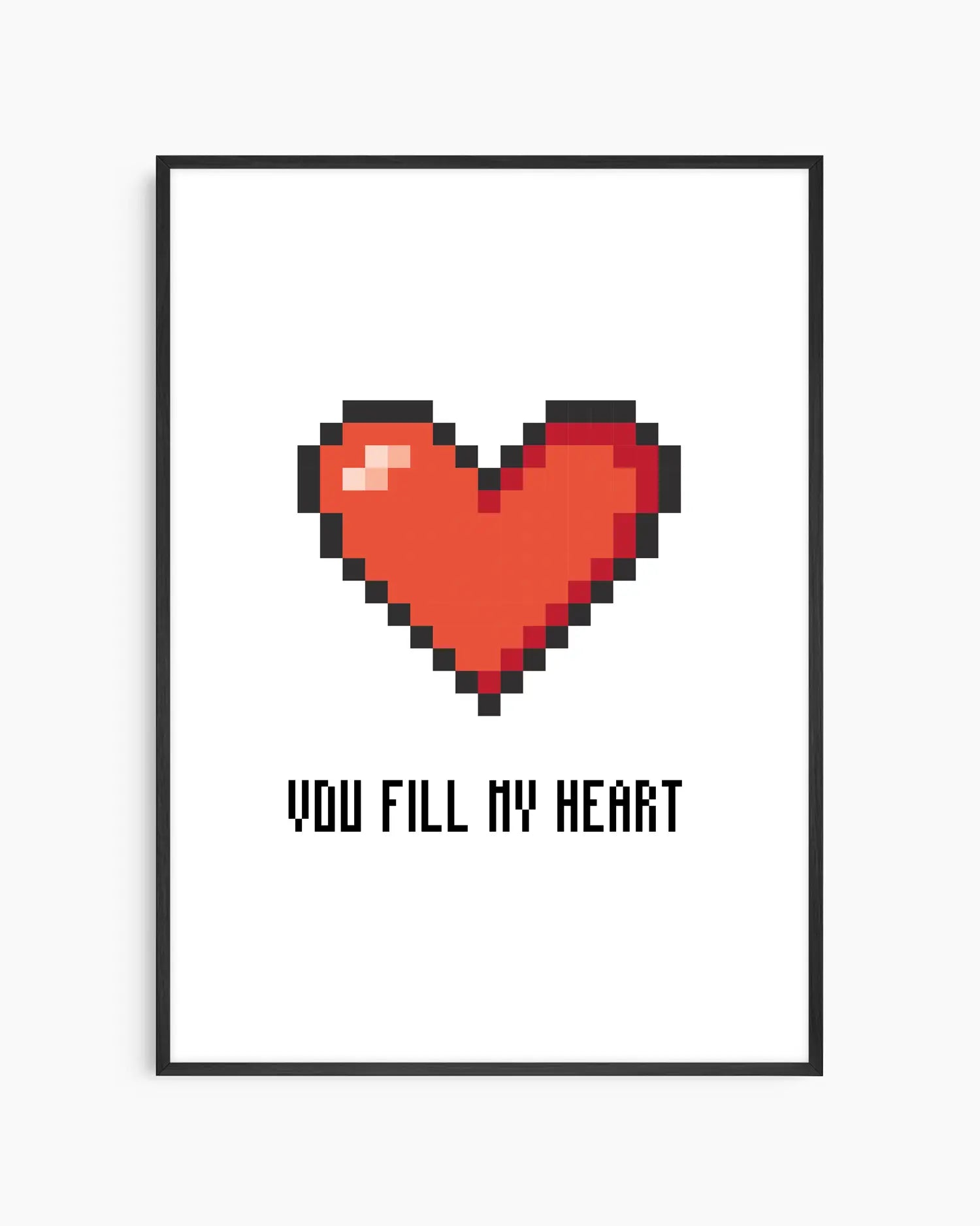 Barntavla med ett pixlat rött hjärta och texten "YOU FILL MY HEART" i svart, mot vit bakgrund, inramad i svart träram. En charmig och retroinspirerad design.