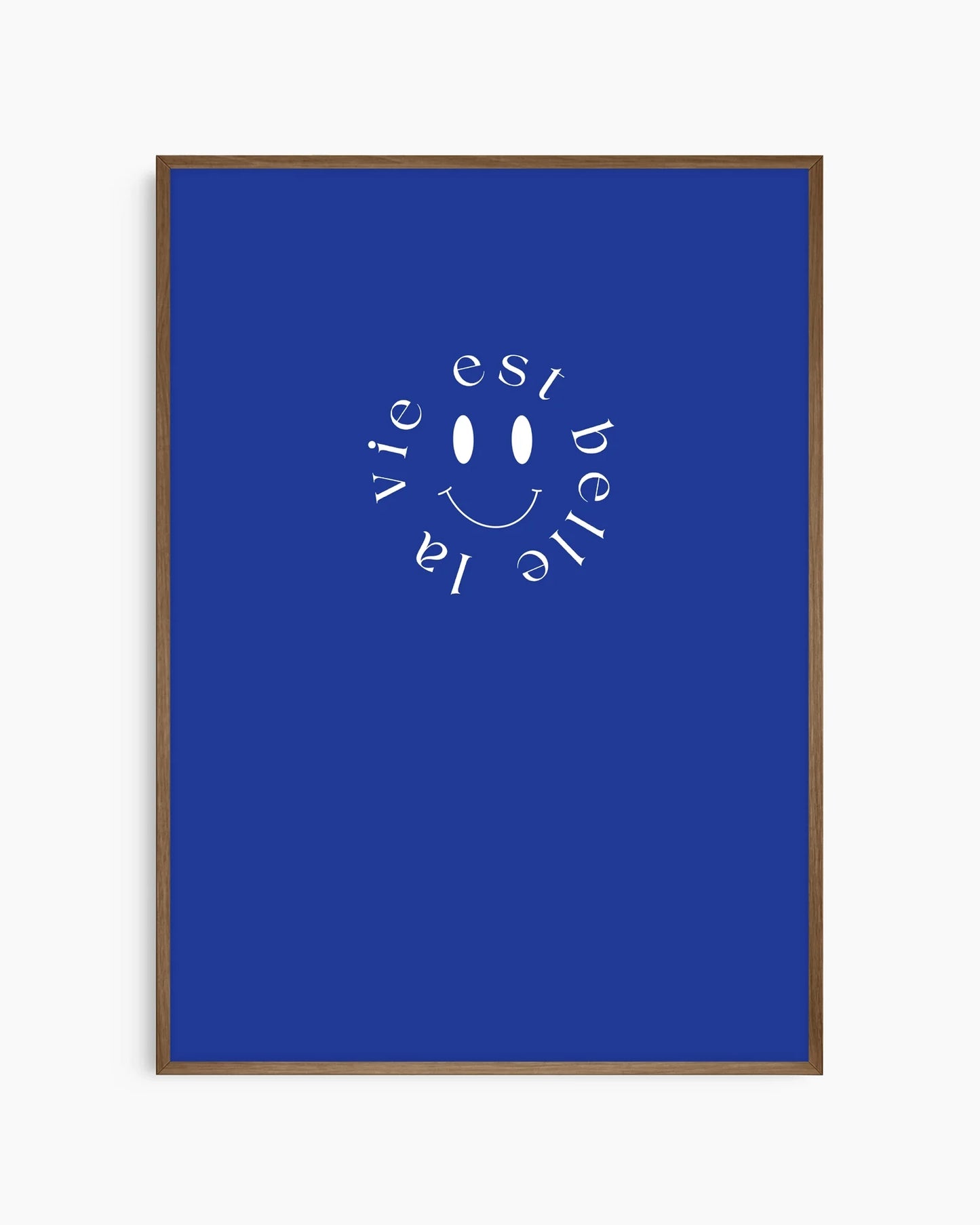 Barntavla med cirkelformad vit smiley och fransk text på blå bakgrund, inramad i mörk ekram som tillför värme och elegans.