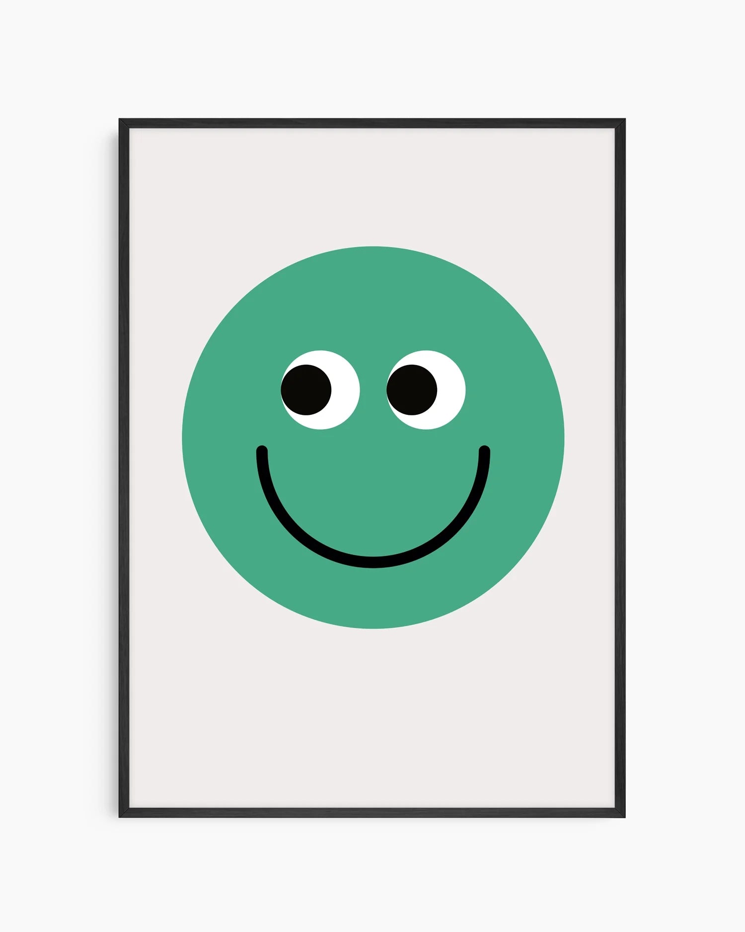 Barntavla med grön smiley på ljus bakgrund, inramad i svart träram som ger ett stilrent och modernt uttryck.