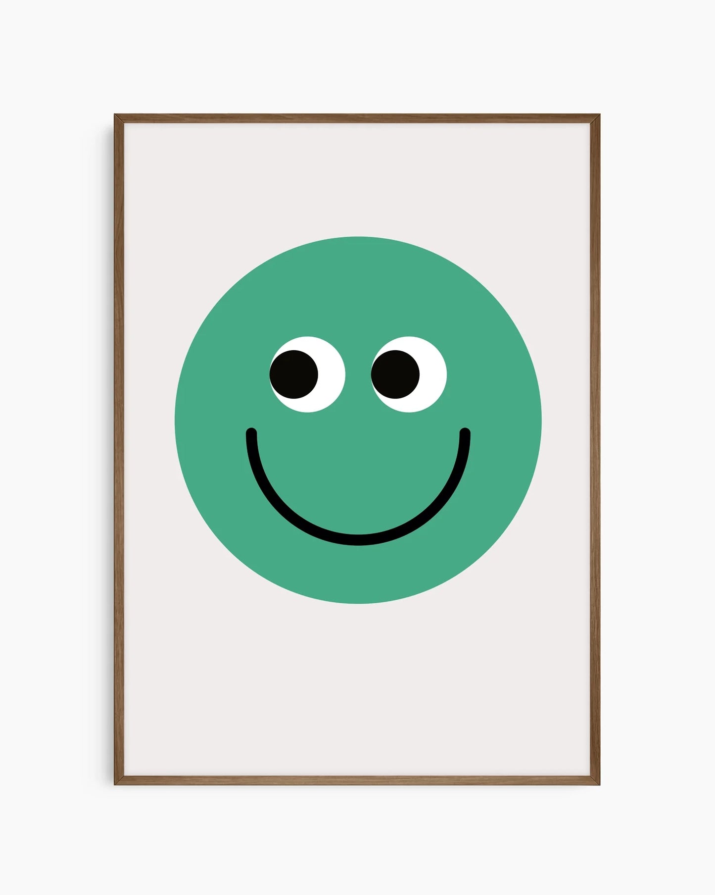 Barntavla med enkel grön smiley, inramad i mörk ekram som tillför värme och kontrast.
