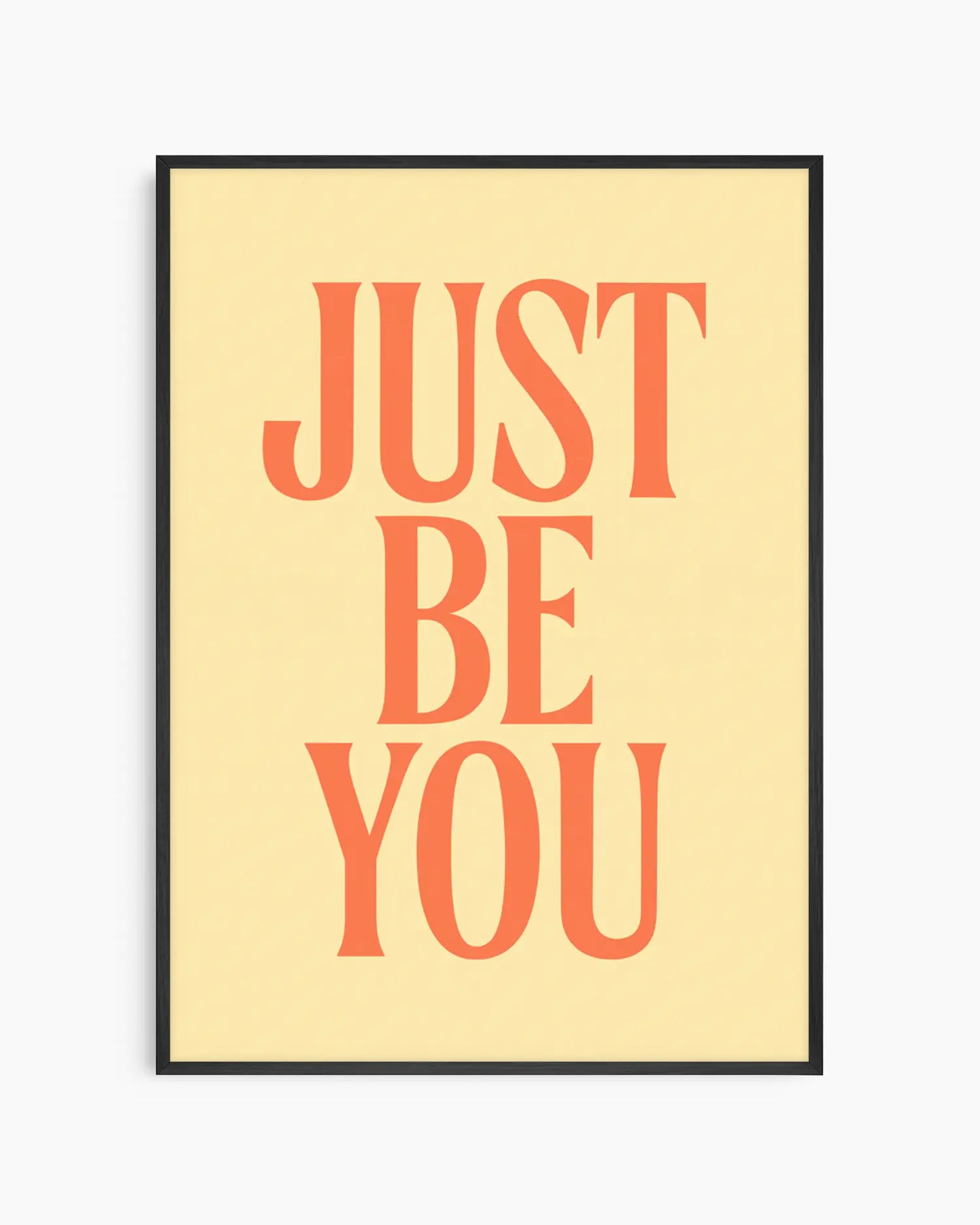 Barntavla med texten "JUST BE YOU" i varm orange typografi på ljus gul bakgrund, inramad i svart träram. En positiv och modern väggdekoration.