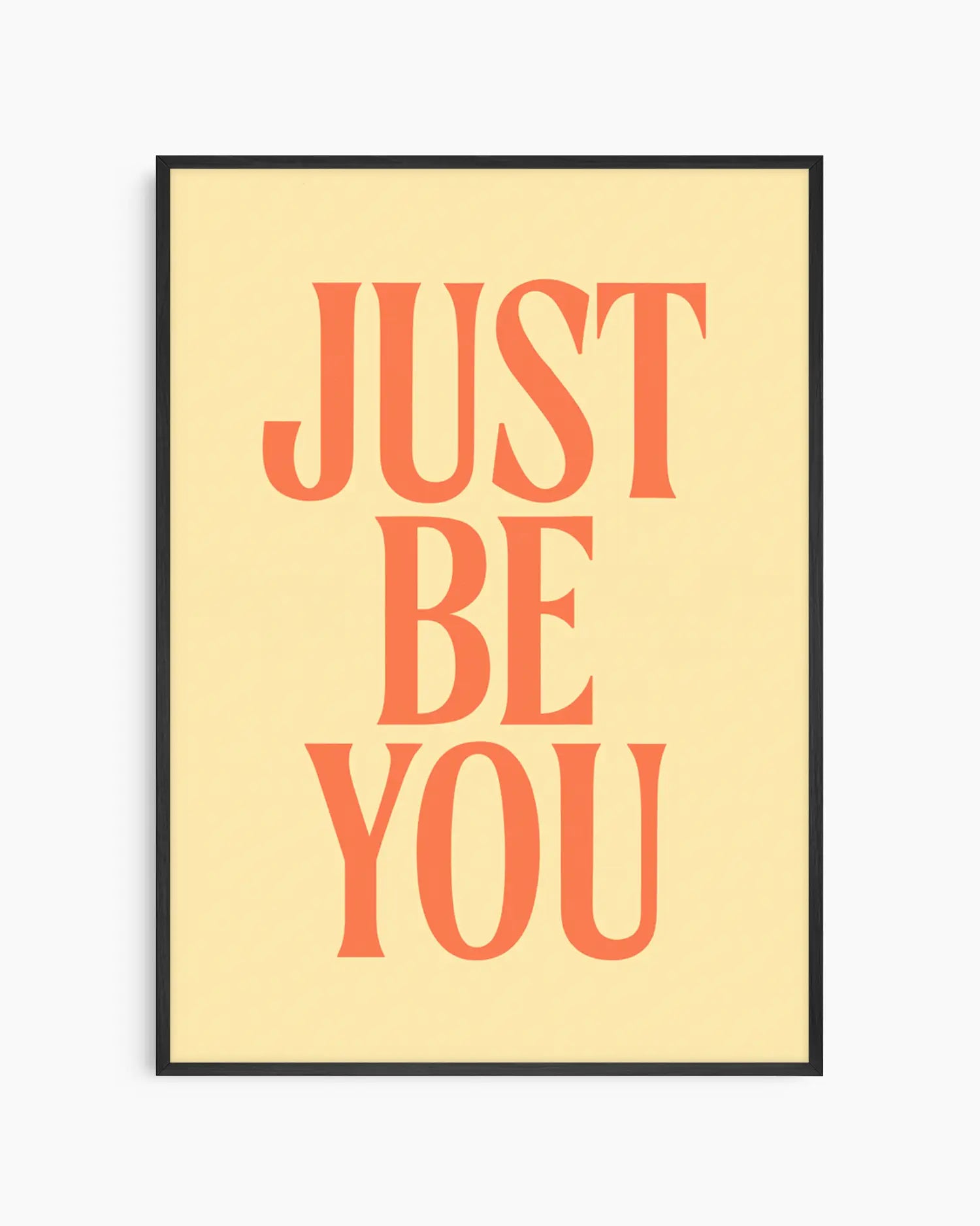 Barntavla med texten "JUST BE YOU" i varm orange typografi på ljus gul bakgrund, inramad i svart träram. En positiv och modern väggdekoration.