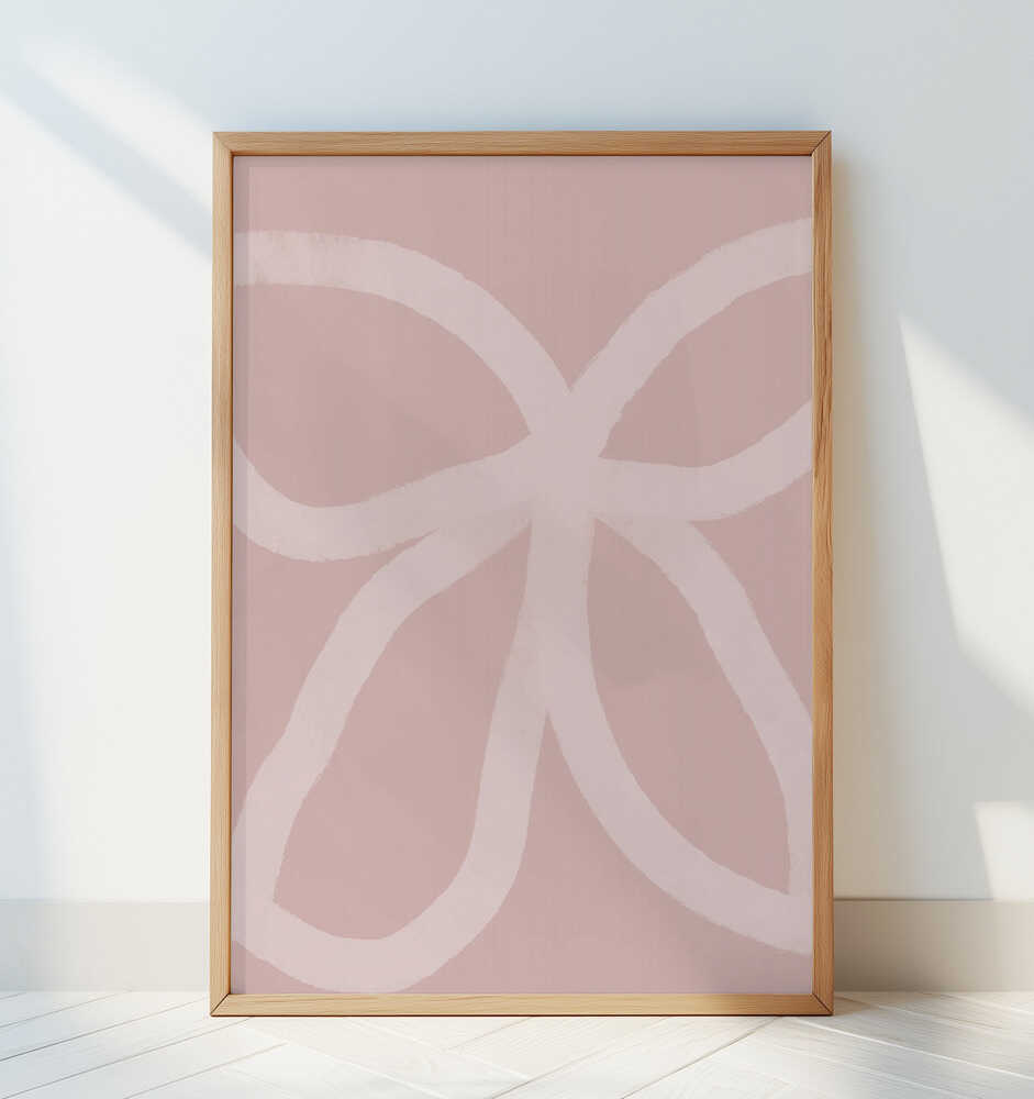 Barntavla med rosa abstrakta linjer lutad mot en vit vägg och tillför ett lugnt och harmoniskt uttryck.