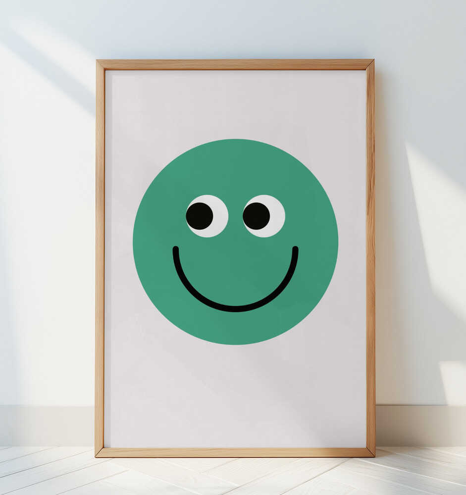 Barntavla med grön smiley lutad mot en vit vägg, vilket framhäver det grafiska motivets tydliga form.