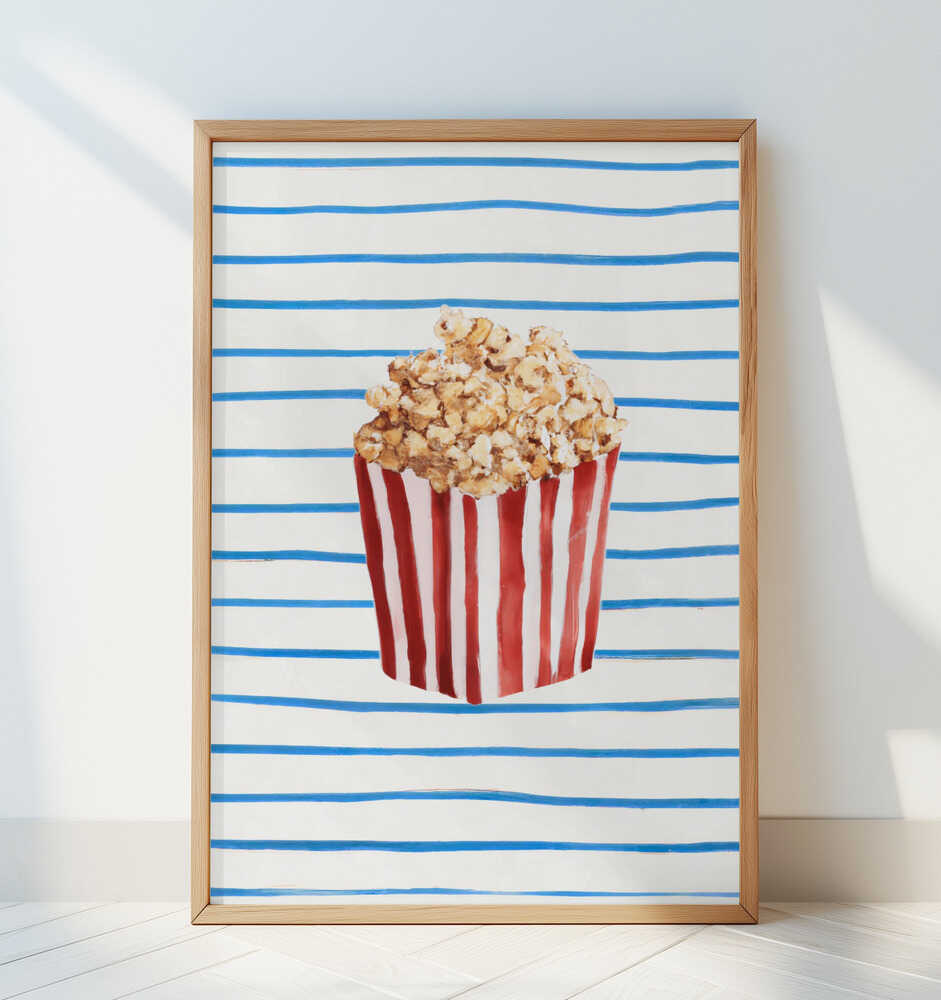 Inramad barntavla med popcornillustration lutad mot en vit vägg på golvet. En stilren och lekfull scen i barnrummet.